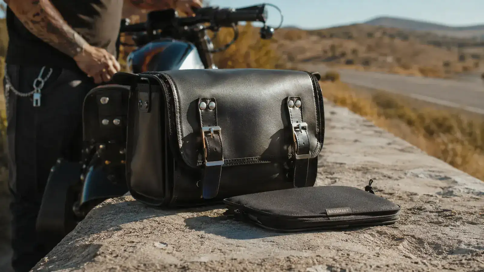 BAGSMART toiletry bag laid flat on a motorcycle saddlebag showing its compact folded size